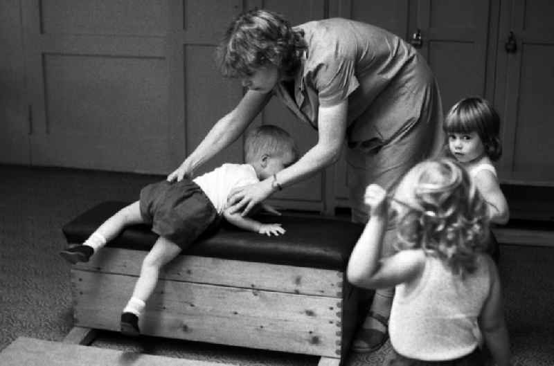 Games and fun with toddlers in kindergarten in physical education in a gym in Berlin Eastberlin on the territory of the former GDR, German Democratic Republic