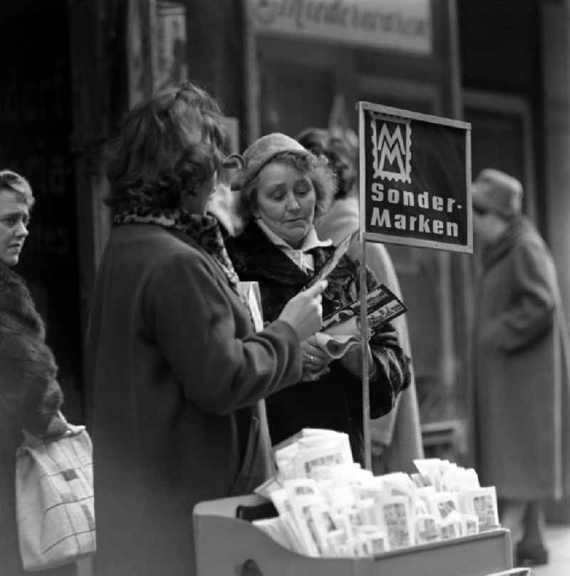 Women look at special postage stamps in Berlin Eastberlin on the territory of the former GDR, German Democratic Republic