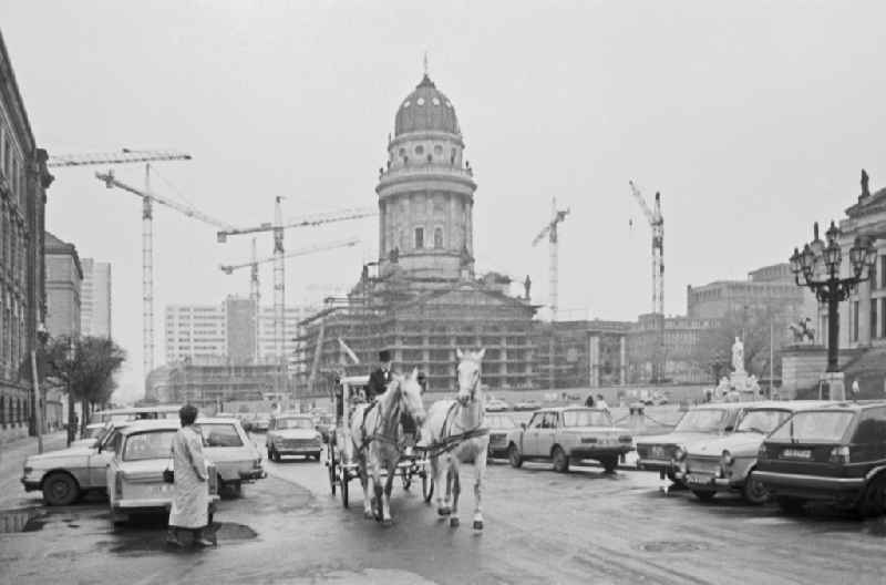 Historic old horse-drawn carriage in front of the cathedral facade and roof of the sacred building 'German Cathedral' at the Schauspielhaus on Jaegerstrasse - Gendarmenmarkt in Berlin, East Berlin in the territory of the former GDR, German Democratic Republic