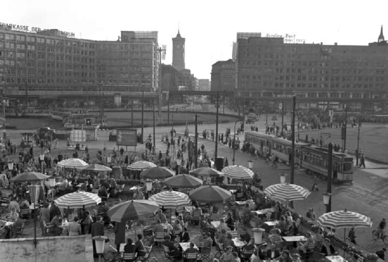 Visitors and guests at the tables of the open-air restaurant on Alexanderplatz in the Mitte district of Berlin, East Berlin in the area of the former GDR, German Democratic Republic