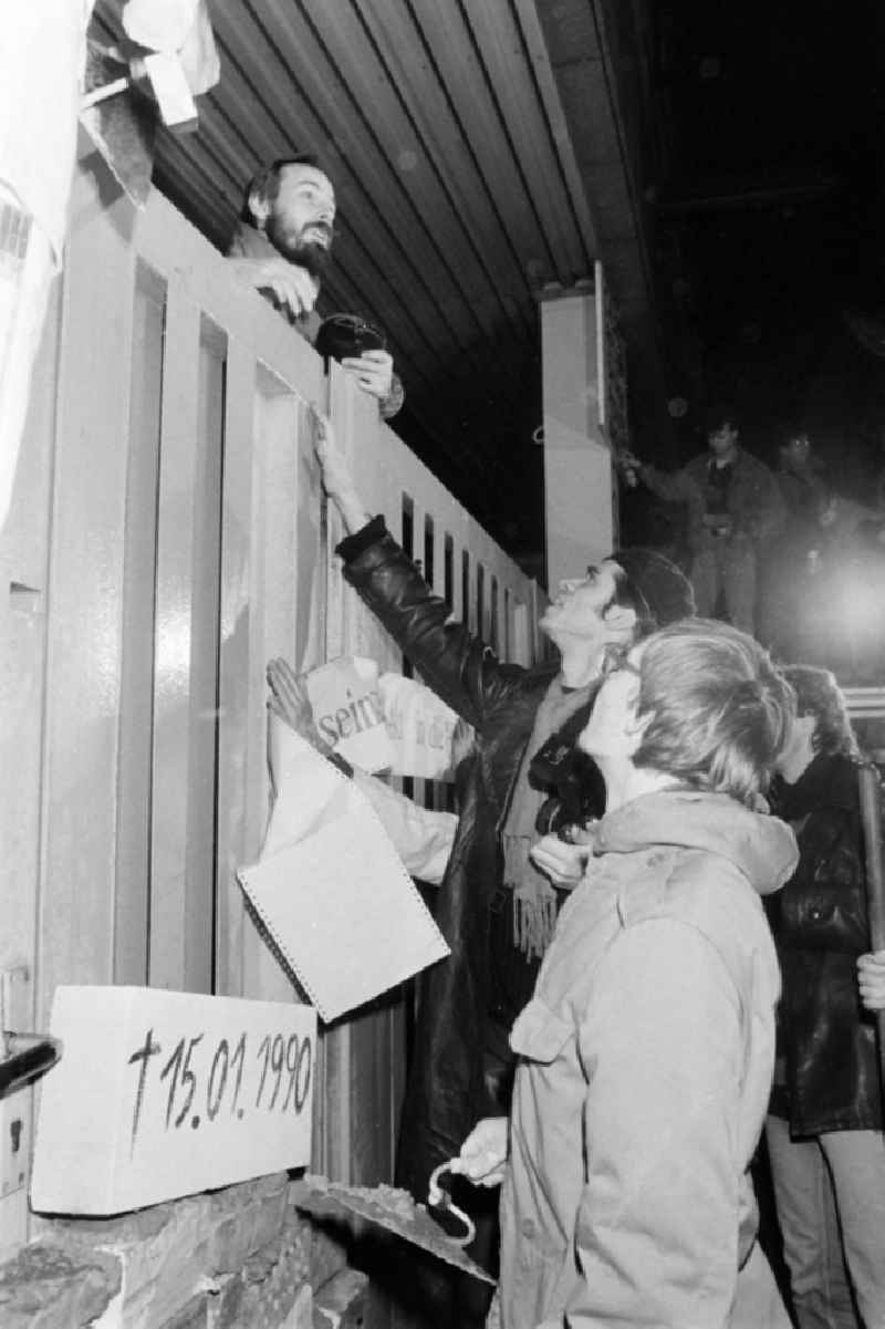 Demonstrators and protesters during the storming and occupation the headquarters of the MfS Ministry for State Security on street Ruschestrasse - Normannenstrasse in the district Lichtenberg in Berlin Eastberlin on the territory of the former GDR, German Democratic Republic