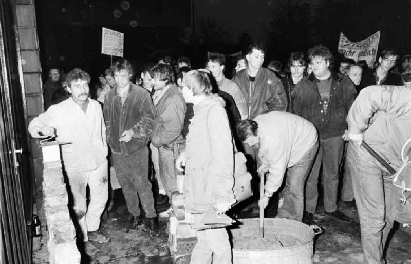 Demonstrators and protesters during the storming and occupation the headquarters of the MfS Ministry for State Security on street Ruschestrasse - Normannenstrasse in the district Lichtenberg in Berlin Eastberlin on the territory of the former GDR, German Democratic Republic