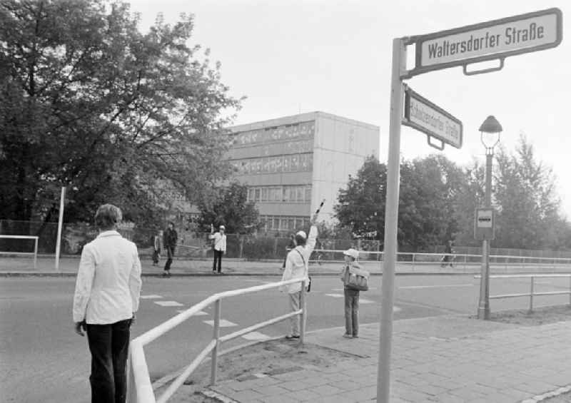 School crossing guards on the way to school for pedestrians and passers-by in traffic at the intersection at Schulzendorfer Strasse and Waltersdorfer Strasse in the district of Bohnsdorf in Berlin East Berlin in the area of the former GDR, German Democratic Republic