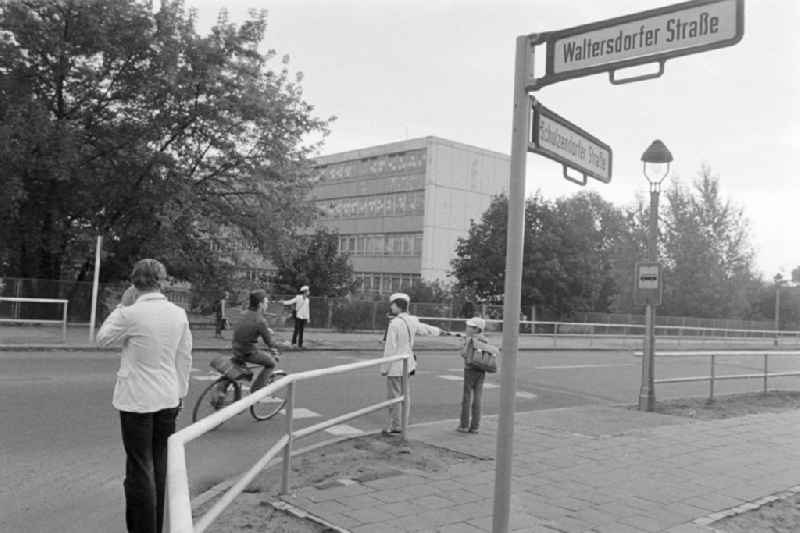 School crossing guards on the way to school for pedestrians and passers-by in traffic at the intersection at Schulzendorfer Strasse and Waltersdorfer Strasse in the district of Bohnsdorf in Berlin East Berlin in the area of the former GDR, German Democratic Republic