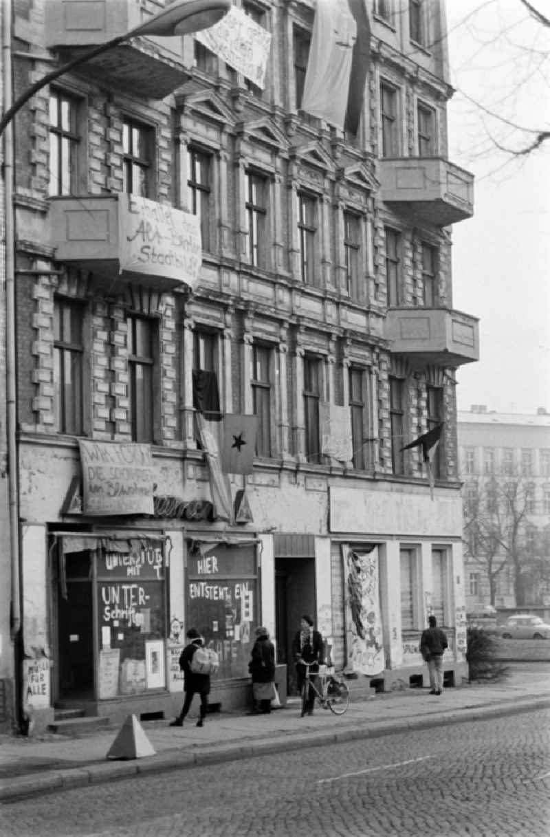 Facades of an occupied old apartment building Schoenhauser Allee 2