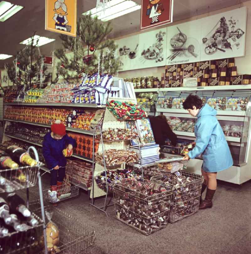 Mall shopping center with shelf offers for Christmas time on street Spandauer Strasse in the district Mitte in Berlin Eastberlin on the territory of the former GDR, German Democratic Republic