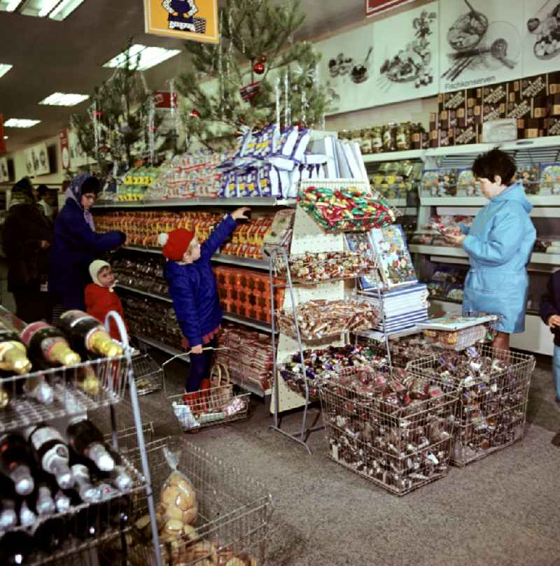 Mall shopping center with shelf offers for Christmas time on street Spandauer Strasse in the district Mitte in Berlin Eastberlin on the territory of the former GDR, German Democratic Republic