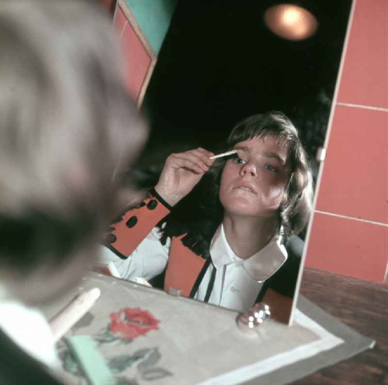 Young artist combing his hair in front of the mirror in preparation for his performance at the Circus Busch in East Berlin, part of the former GDR, German Democratic Republic