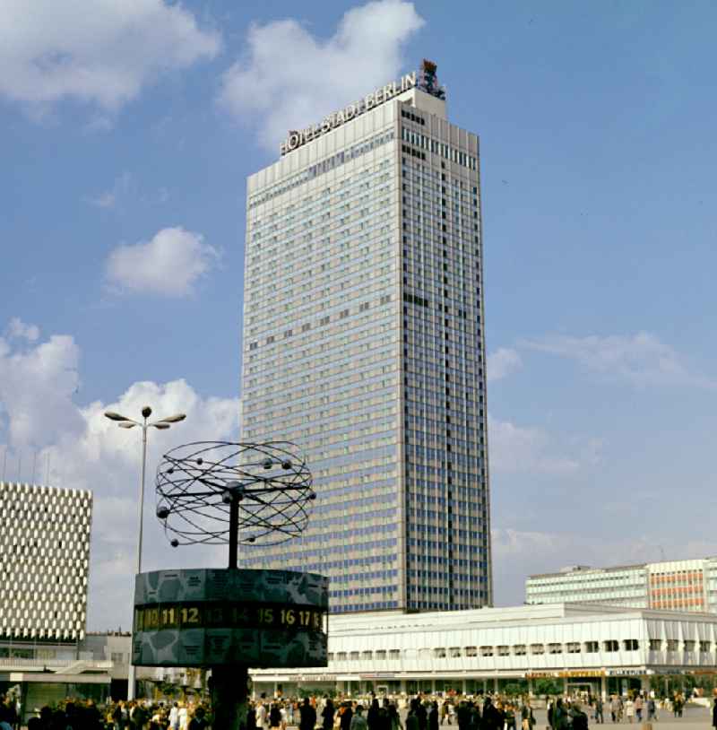 Tourist attraction and landmark 'World Time Clock' in the background 'Hotel Stadt Berlin' at Alexanderplatz in the Mitte district of Berlin East Berlin in the territory of the former GDR, German Democratic Republic