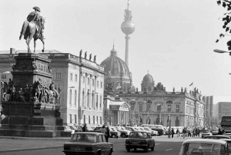 Equestrian monument of Frederick II in front of the Humboldt University in traffic on the street Unter den Linden in the Mitte district of Berlin, East Berlin in the territory of the former GDR, German Democratic Republic