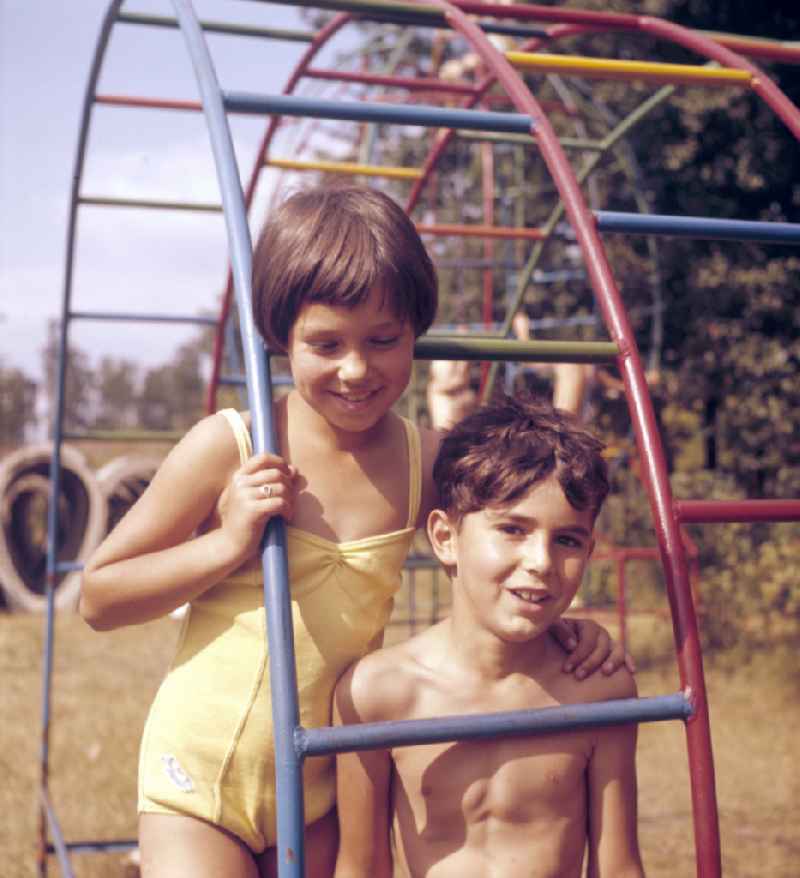 Children on a climbing frame in the outdoor pool on the street Sportpromenade in Berlin East Berlin in the territory of the former GDR, German Democratic Republic