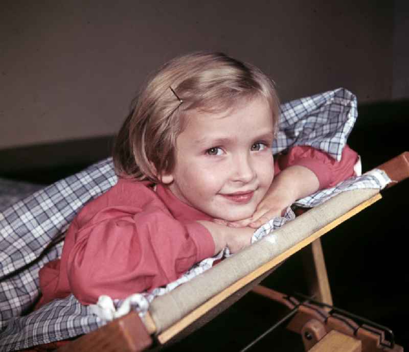 A little girl taking a nap in the kindergarten on Michael-Brueckner-Strasse in the Schoeneweide district of Berlin in the territory of the former GDR, German Democratic Republic