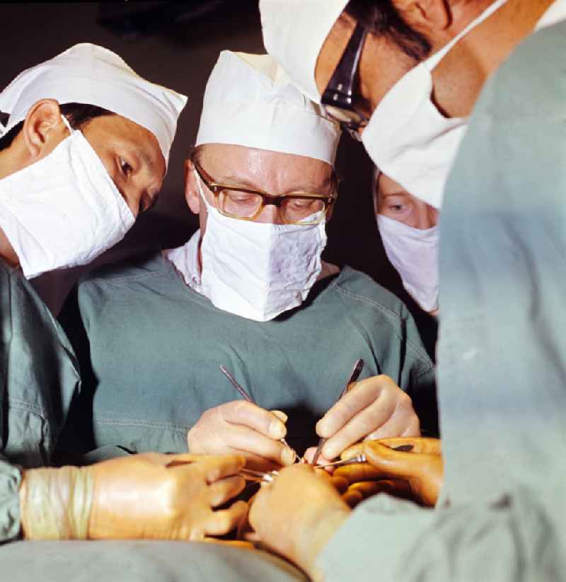 Professor Dr. Hans Gummel providing patient care in a clinic by operating in an operating room 'Robert-Roessle-Klinik' on Robert-Roessle-Strasse in the district of Buch in Berlin East Berlin in the area of the former GDR, German Democratic Republic