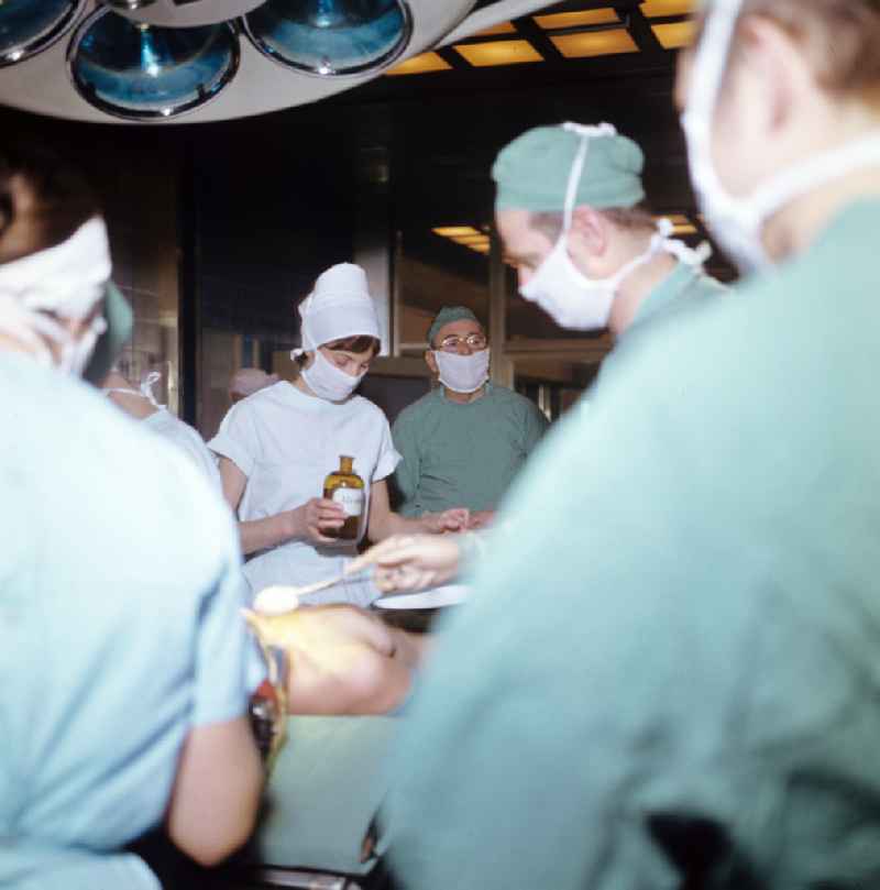 Professor Dr. Hans Gummel providing patient care in a clinic by operating in an operating room 'Robert-Roessle-Klinik' on Robert-Roessle-Strasse in the district of Buch in Berlin East Berlin in the area of the former GDR, German Democratic Republic