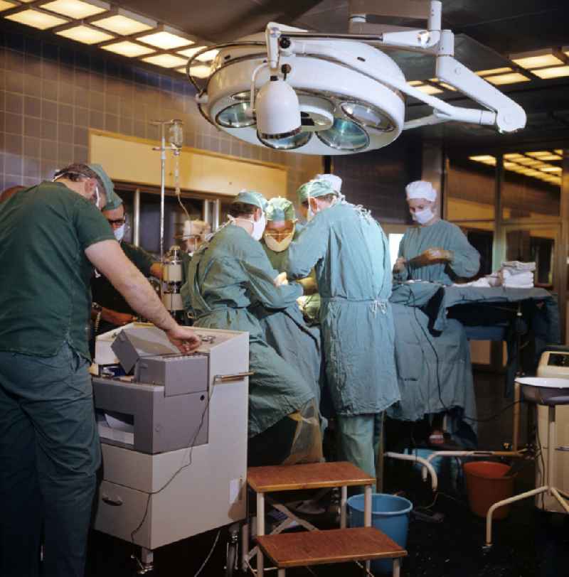 Professor Dr. Hans Gummel providing patient care in a clinic by operating in an operating room 'Robert-Roessle-Klinik' on Robert-Roessle-Strasse in the district of Buch in Berlin East Berlin in the area of the former GDR, German Democratic Republic