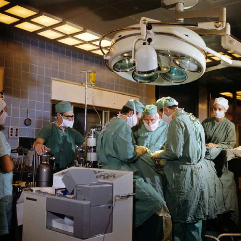 Professor Dr. Hans Gummel providing patient care in a clinic by operating in an operating room 'Robert-Roessle-Klinik' on Robert-Roessle-Strasse in the district of Buch in Berlin East Berlin in the area of the former GDR, German Democratic Republic