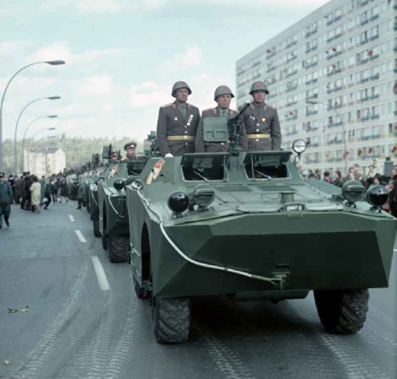 Enthusiastic population forming a guard of honor for the parade drive of military and combat technology 'Armored infantry vehicle SPW BRDM-1' on Lichtenberger Strasse in the district of Friedrichshain in East Berlin in the territory of the former GDR, German Democratic Republic