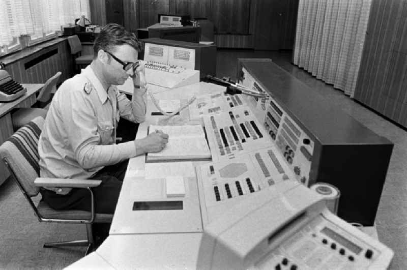 Police officer in uniformin Uniform der Deutschen Volkspolizei im Lagezentrum on street Keibelstrasse in the district Mitte in Berlin Eastberlin on the territory of the former GDR, German Democratic Republic