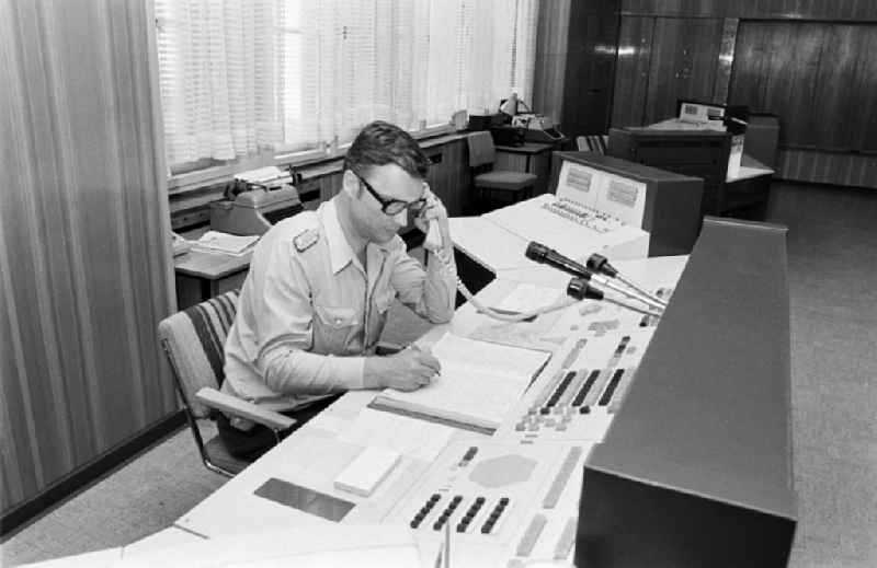 Police officer in uniformin Uniform der Deutschen Volkspolizei im Lagezentrum on street Keibelstrasse in the district Mitte in Berlin Eastberlin on the territory of the former GDR, German Democratic Republic