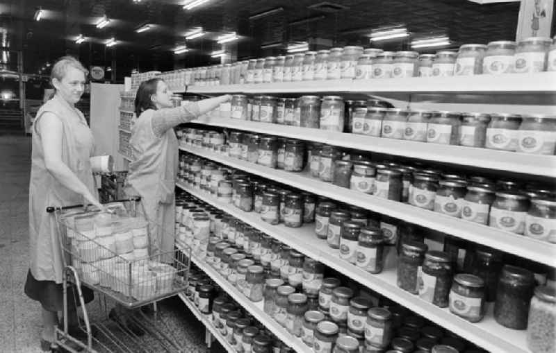 Saleswomen stocking the shelves in the Kaufhalle shopping centre on Schoenhauser Allee in the Pankow district of Berlin, East Berlin, in the territory of the former GDR, German Democratic Republic