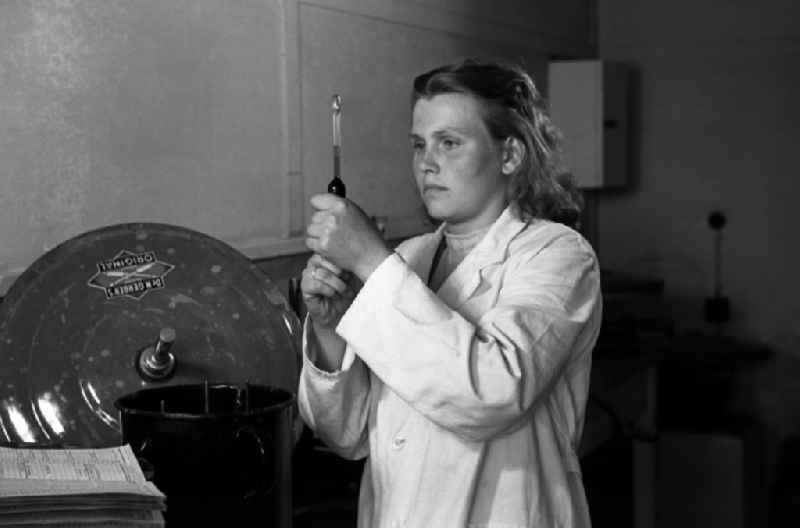 Laboratory assistant in a white coat draws up liquid in a pipette in an publicly owned property animal breeding in Pillnitz in Dresden in the state Saxony on the territory of the former GDR, German Democratic Republic