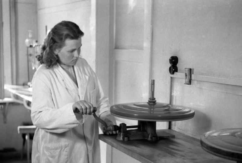 Laboratory assistant in a white coat operates a centrifuge in an publicly owned property animal breeding in Pillnitz in Dresden in the state Saxony on the territory of the former GDR, German Democratic Republic