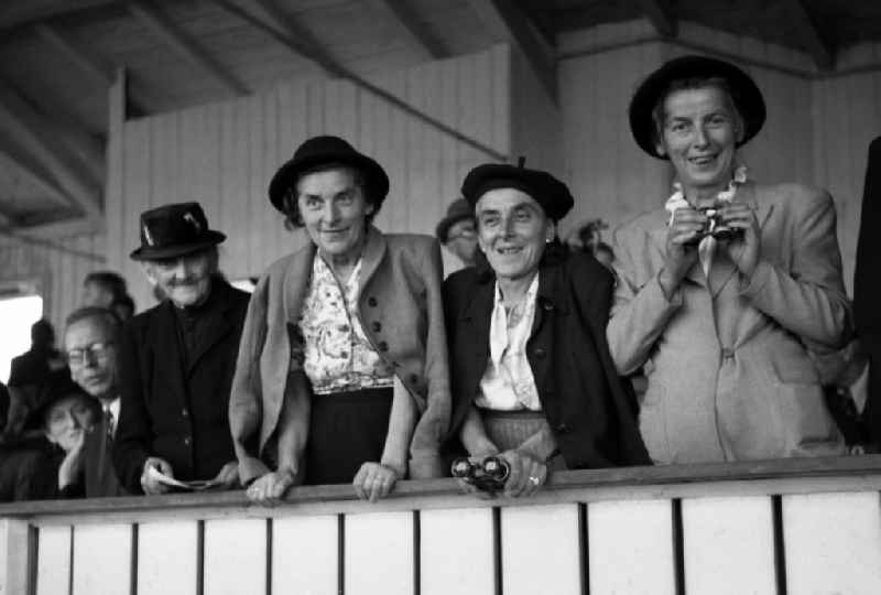 Spectator with hat on the grandstand of the racecourse Dresden Seidnitz in the federal state Saxony on the territory of the former GDR, German Democratic Republic