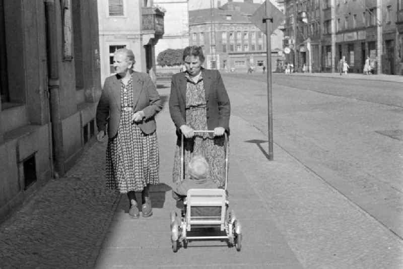 Two women with strollers along Rossmaesslerstrasse in the Mickten district of Dresden, Saxony in the territory of the former GDR, German Democratic Republic
