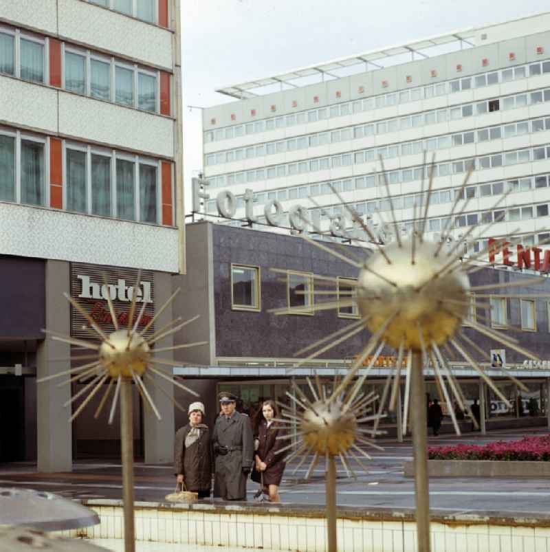 Officer of the Air Force National People's Army NVA with his family in front of the popular water feature fountain 'Pusteblumenbrunnen' on Sankt Petersburger Strasse in Dresden, Saxony in the territory of the former GDR, German Democratic Republic