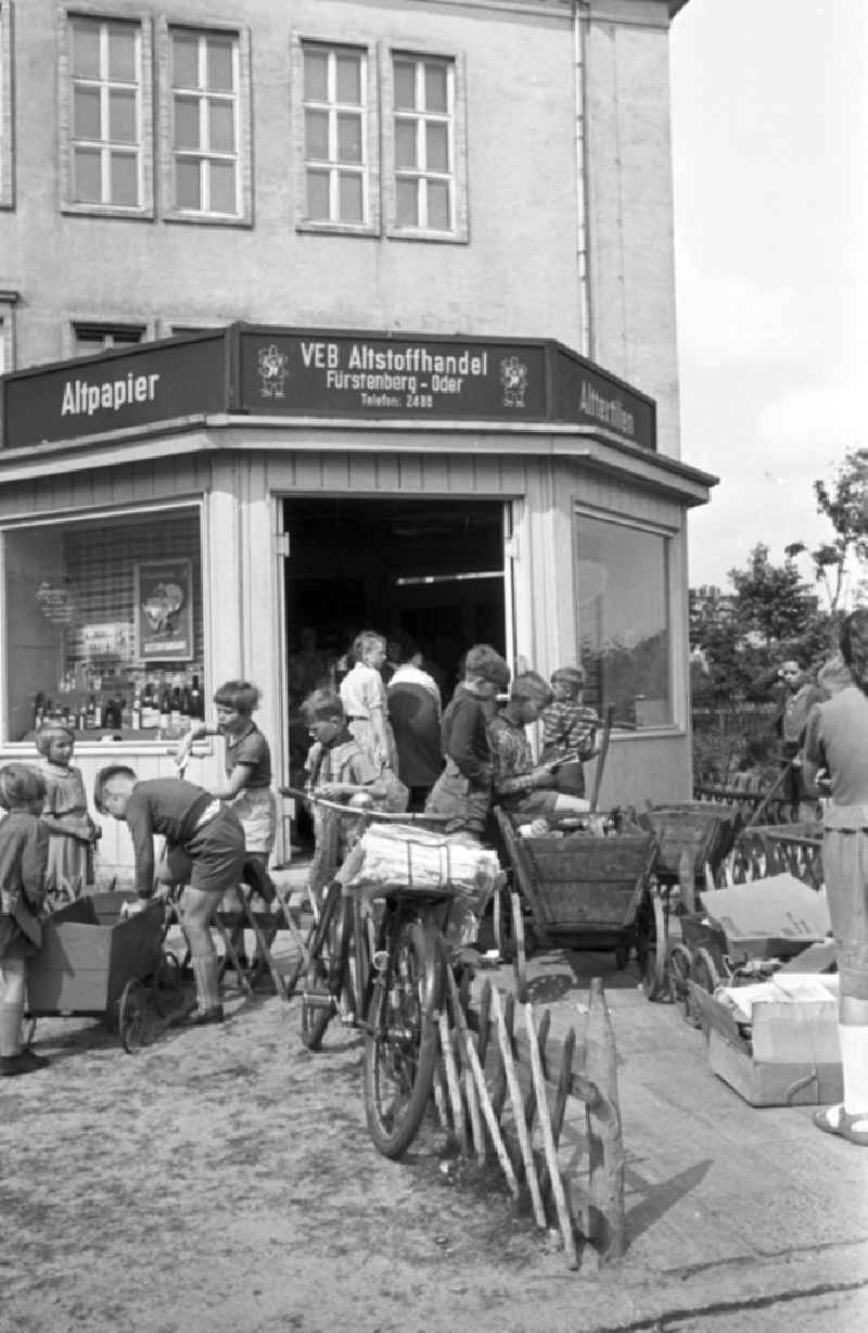 Children handing in waste materials, waste paper, bottles and gases as secondary raw materials for collection at the state-run SERO collection points in Fuerstenberg-Oder (Eisenhuettenstadt), Brandenburg in the area of the former GDR, German Democratic Republic