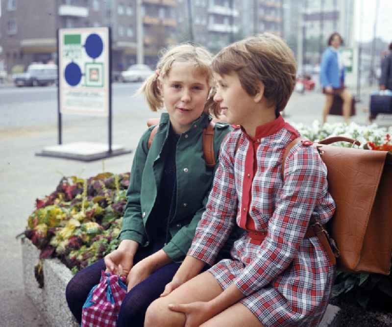 Two girls take a break on their way to school in Frankfurt (Oder), Brandenburg in the territory of the former GDR, German Democratic Republic