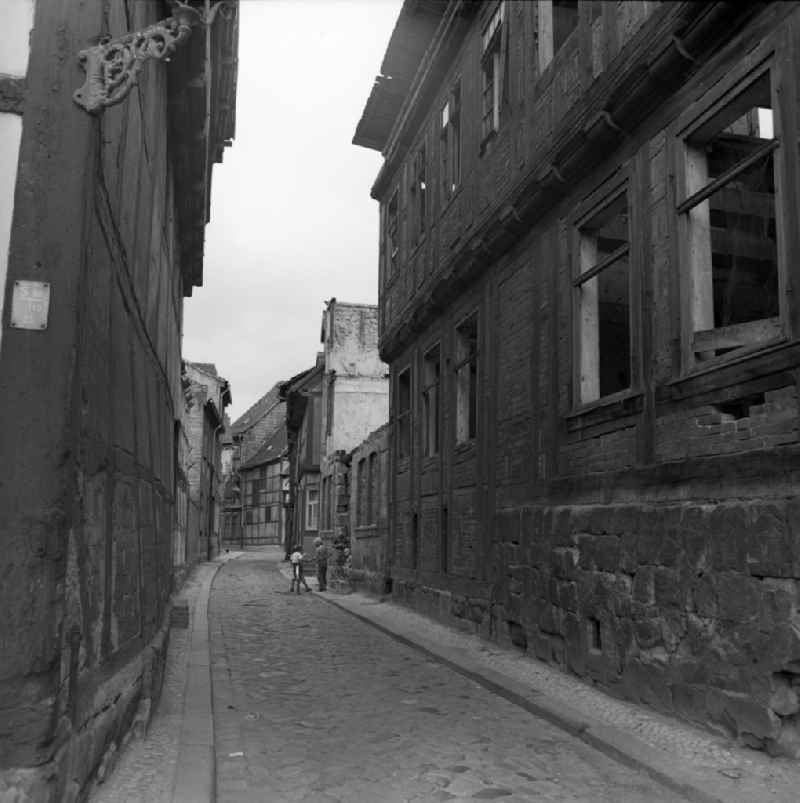 Rubble and ruins Rest of the facade and roof structure of the half-timbered house in the Ochsenkopfstrasse in Halberstadt in the state Saxony-Anhalt on the territory of the former GDR, German Democratic Republic