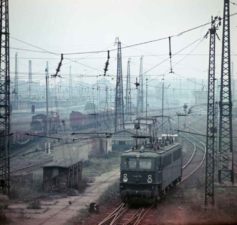 Work on the assembly of copper overhead lines - power lines on the rails and over the track systems on the railway line of the DR 'Deutsche Reichsbahn' on the outskirts in Halle (Saale) in the state Saxony-Anhalt on the territory of the former GDR, German Democratic Republic