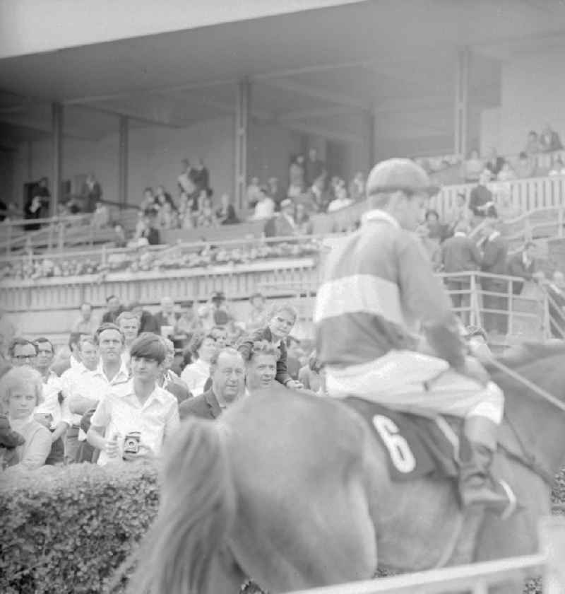 Racehorses and jockeys at the last training lap, at the Hoppegarten racecourse, before the start of the German Derby of the GDR in Hoppegarten in the federal state Brandenburg on the territory of the former GDR, German Democratic Republic