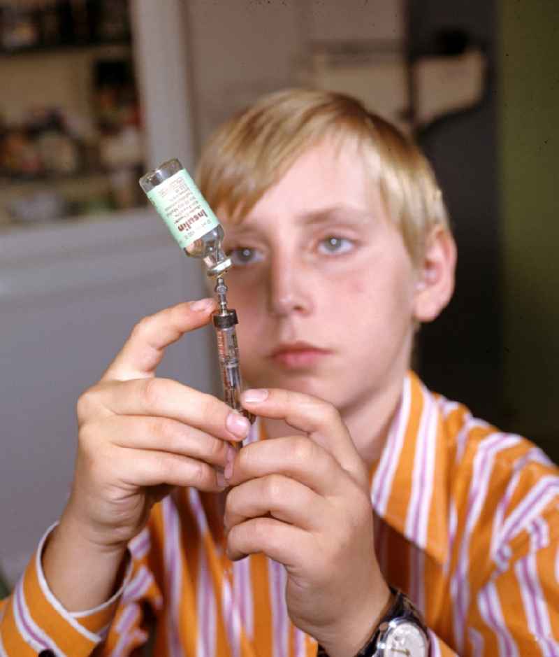 A boy prepares his insulin injection at the Central Institute for Diabetes 'Gerhardt Katsch' in Karlsburg, Mecklenburg-Vorpommern in the territory of the former GDR, German Democratic Republic