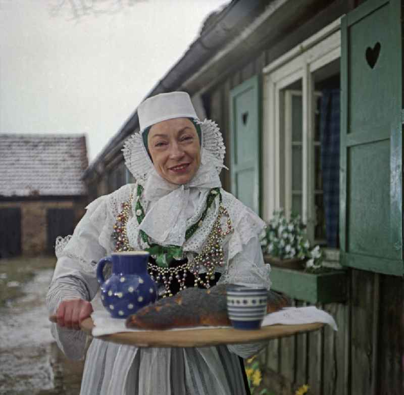 Scene from the film and television production 'Continent Hope' with the actress Majka Kowarjec in Sorbian costume as a mother in front of an old farm in Kreba-Neudorf, Saxony in the area of the former GDR, German Democratic Republic