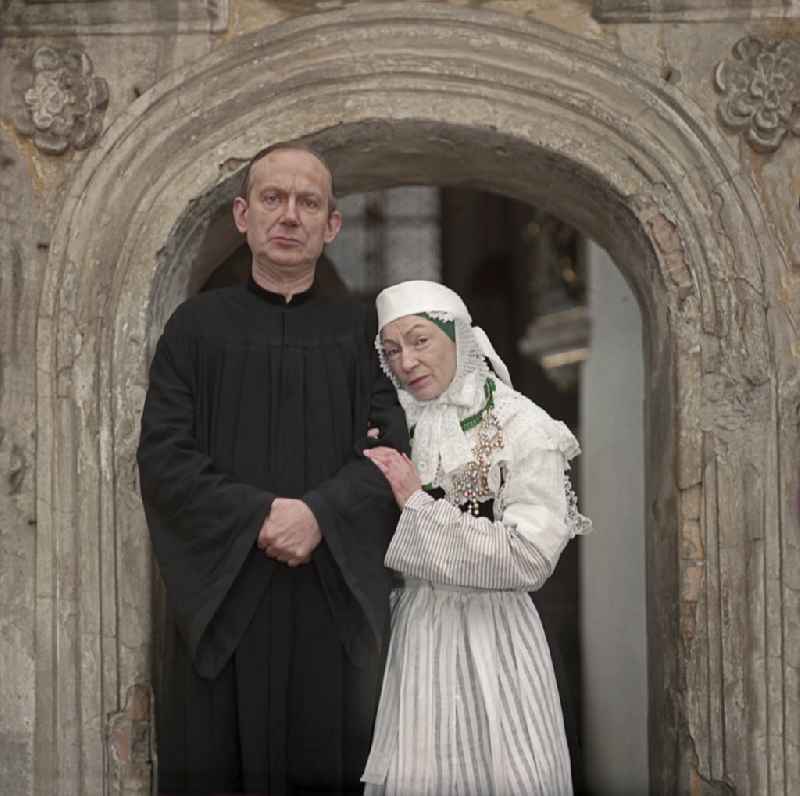 Scene from the film and television production 'Continent Hope' with the actress Majka Kowarjec and the actor Alfred Luebke at the entrance of a church in Kreba-Neudorf, Saxony in the area of the former GDR, German Democratic Republic