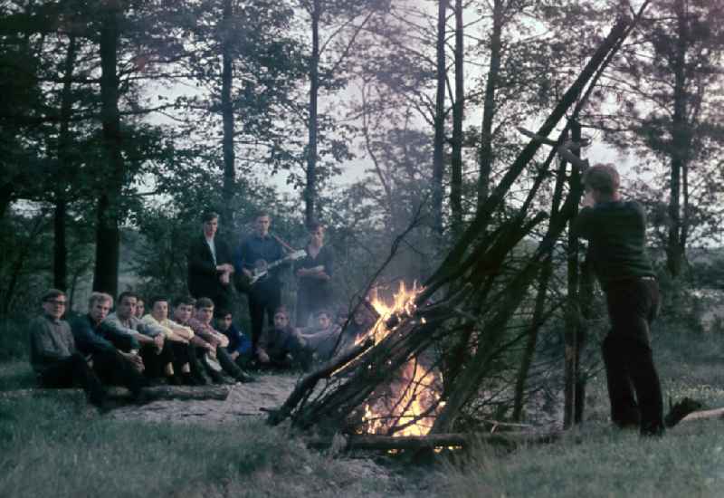 FDJ members at a campfire on the sidelines of a work mission for the melioration and drainage of agricultural land in Nauen, Brandenburg in the territory of the former GDR, German Democratic Republic