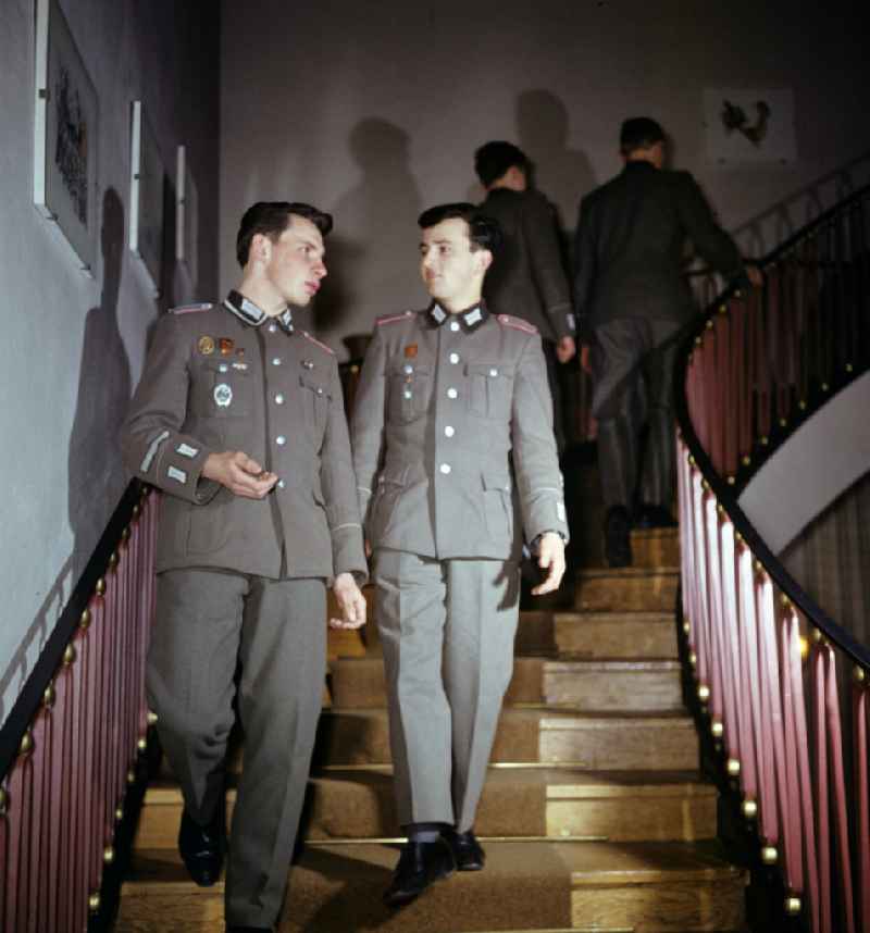 Soldiers - equipment and uniforms of the land forces of the NVA National Peoples Army in their free time reading the newspaper and drinking beer in the common room in a barracks accommodation in Oranienburg, Brandenburg in the territory of the former GDR, German Democratic Republic