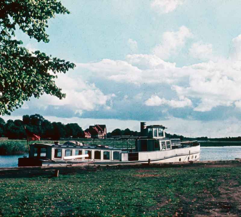 Boat in the landing stage in the harbour in the Prerower stream in Prerow in the federal state Mecklenburg-West Pomerania in the area of the former GDR, German democratic republic
