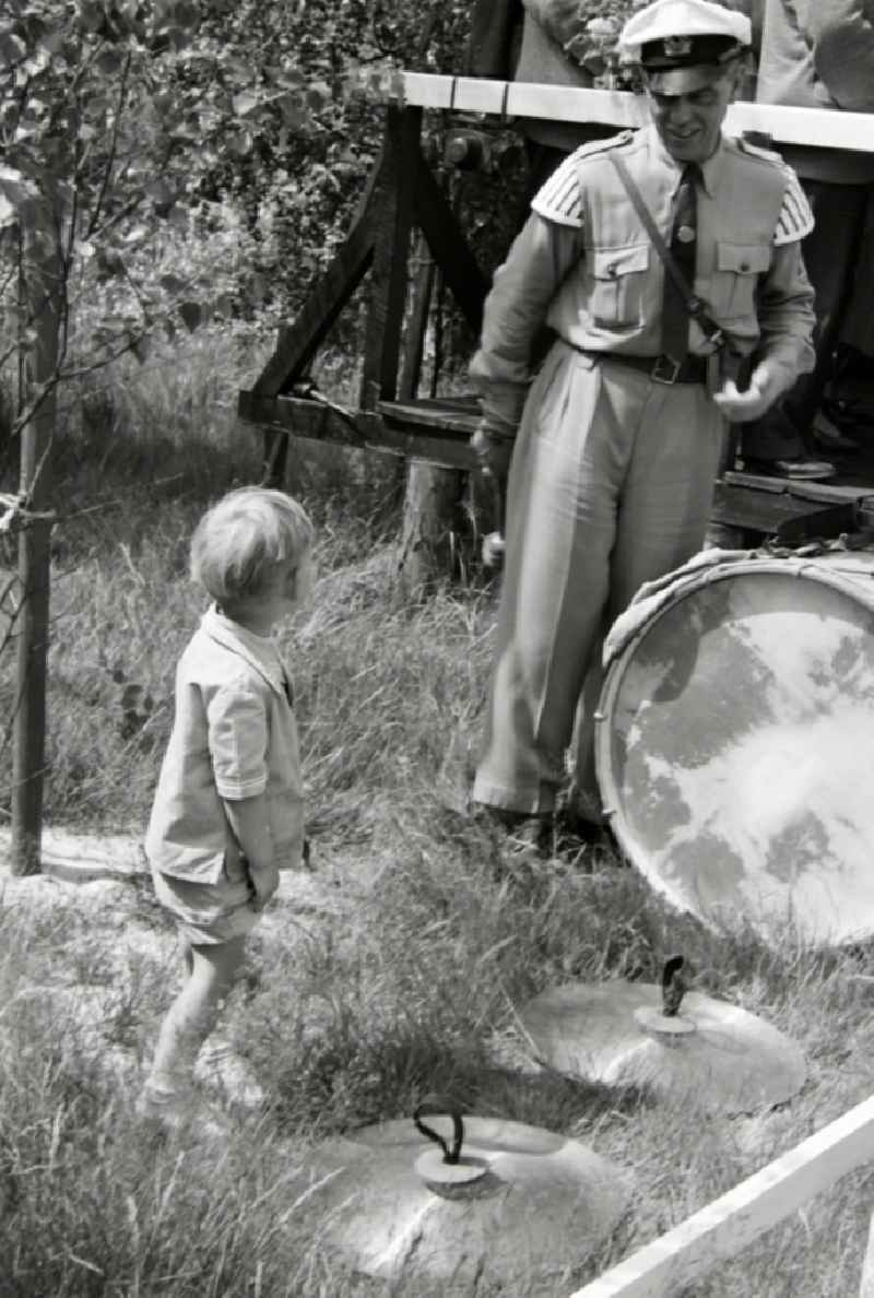 Young boy interested in music at the summer camp 'Kim Ir Sen' of the pioneer organization 'Ernst Thaelmann' in Prerow in the state of Mecklenburg-Western Pomerania in the area of the former GDR, German Democratic Republic