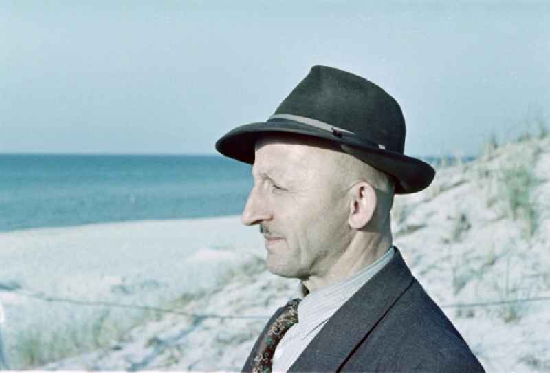 Portrait of the financial officer Bruno Richard Gebser wearing a hat and suit on a midsummer beach in Prerow in the state of Mecklenburg-Vorpommern on the territory of the former GDR, German Democratic Republic