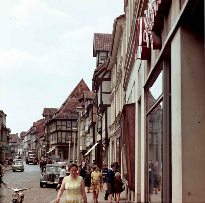 Pedestrians and passers-by in traffic in front of half-timbered house facades in Quedlinburg, Saxony-Anhalt in the area of the former GDR, German Democratic Republic