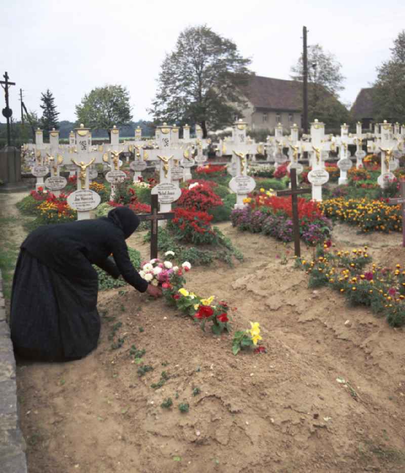 Cultural-historical grave cross and gravestone ensemble in the Sorbian cemetery on the main street in Ralbitz-Rosenthal, Saxony in the territory of the former GDR, German Democratic Republic