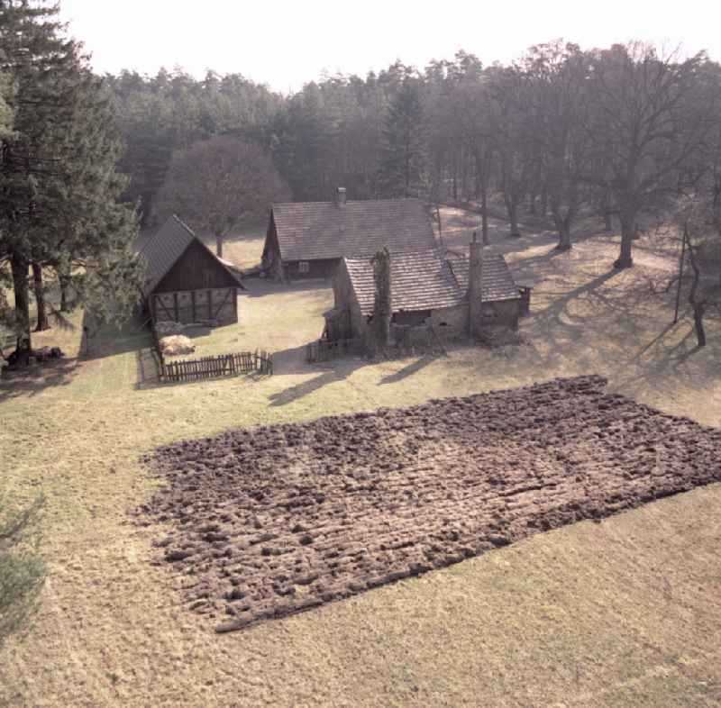 Agricultural work in a farm and farm mit bestellten Acker on street Hauptstrasse in Raeckelwitz, Saxony on the territory of the former GDR, German Democratic Republic