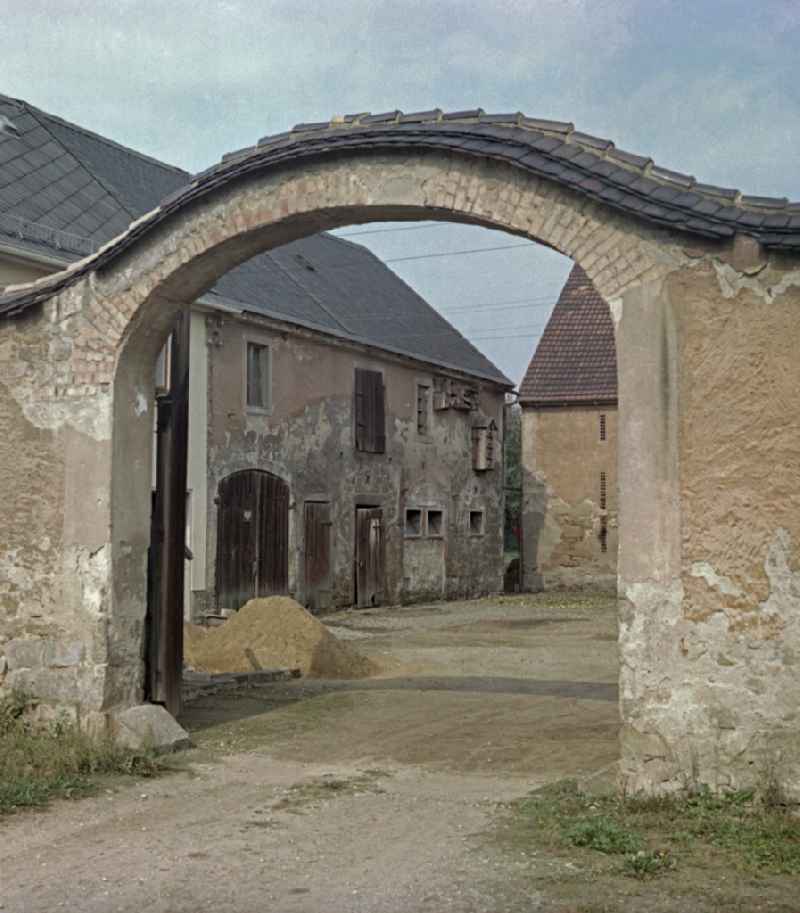 Scene photo from the film 'Portrait of a Center' A Sorbian farmstead. Entrance gate with a brick archway