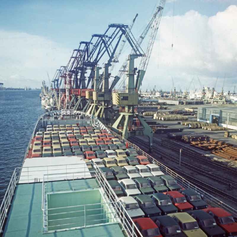 A ship loaded with passenger cars of the type LADA in the overseas port in Rostock in Mecklenburg-Western Pomerania. In the background loading cranes for loading ships