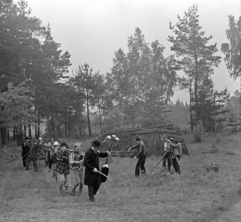 Scene from the film and television production 'Struga - Pictures of a Landscape' with passing musicians and their musical instruments in clown costumes on the road Waldrand in Schleife, Saxony in the area of the former GDR, German Democratic Republic