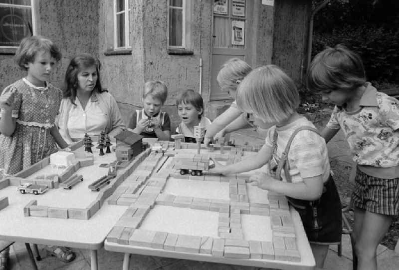 Children play outside in a child cooked in Schulzendorf in the federal state Brandenburg in the area of the former GDR, German democratic republic