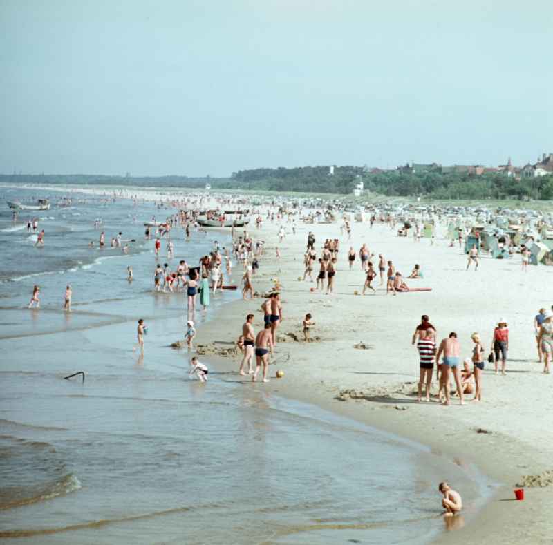 Sandy beach of the Baltic Sea with bathers and holidaymakers on street Duenenstrasse in Seebad Ahlbeck, Mecklenburg-Western Pomerania on the territory of the former GDR, German Democratic Republic